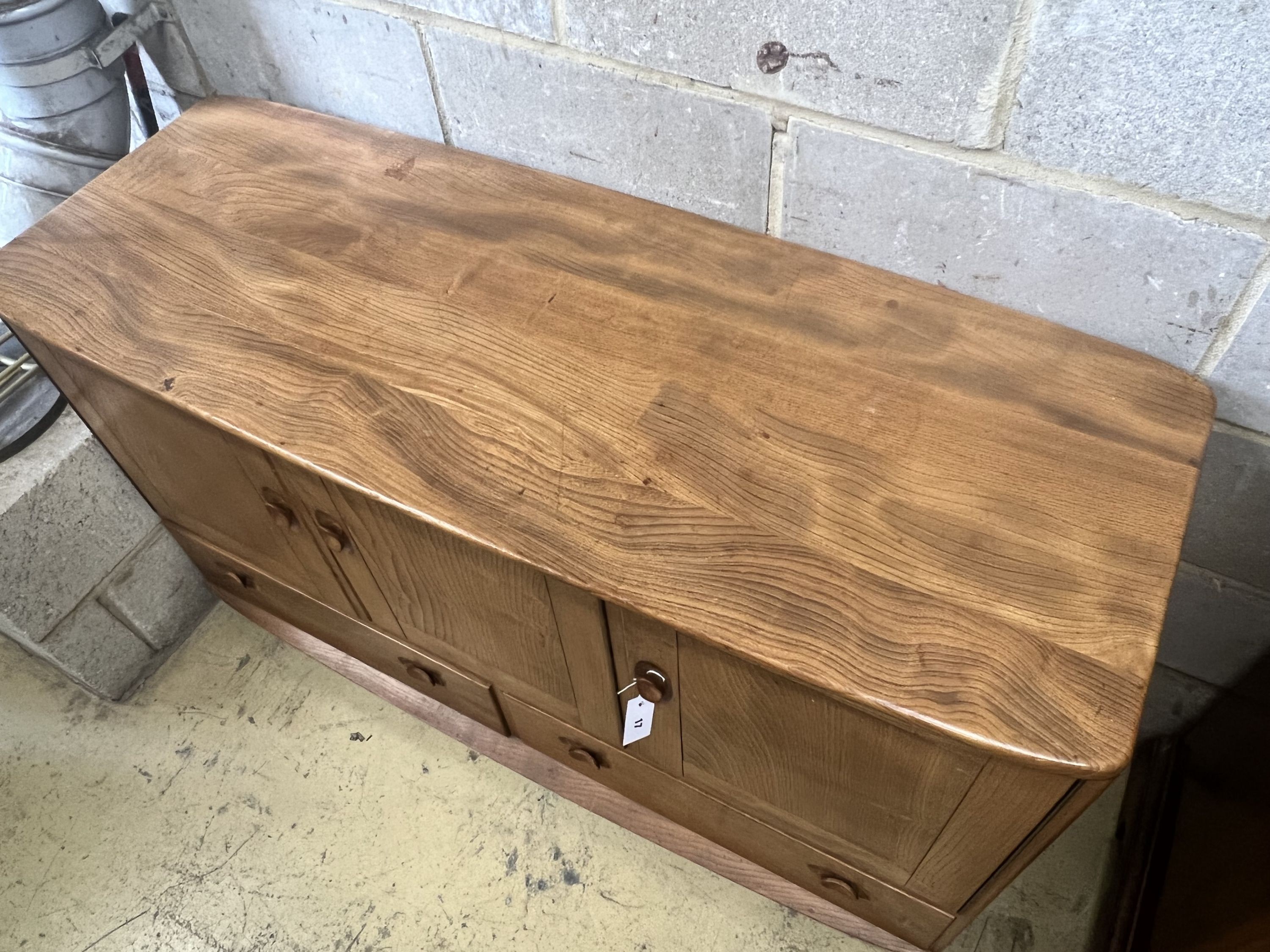 An Ercol honeydew elm sideboard, width 129cm depth 49cm height 6cm